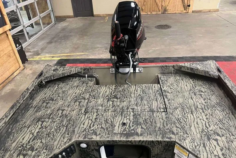 Slide: The Image of 2026 Tracker Grizzly 1654 Sportsman boat with camouflage design and swivel seat. - 4