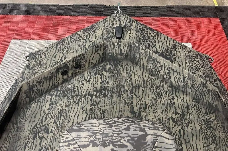 Slide: The Image of 2026 Tracker Grizzly 1654 Sportsman boat on trailer in showroom with branded backdrop. - 6