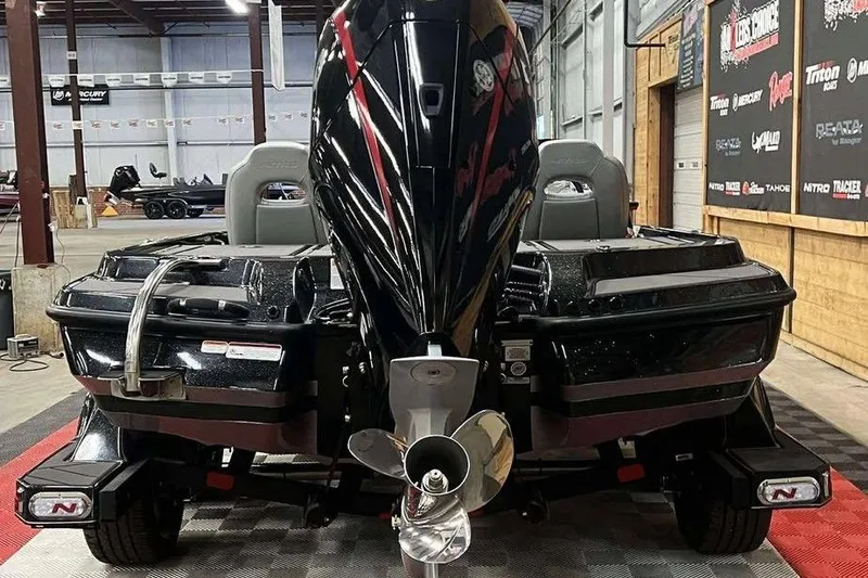 Slide: The Image of 2026 Nitro Z20 XL Pro boat in showroom, rear view with powerful engine. - 2