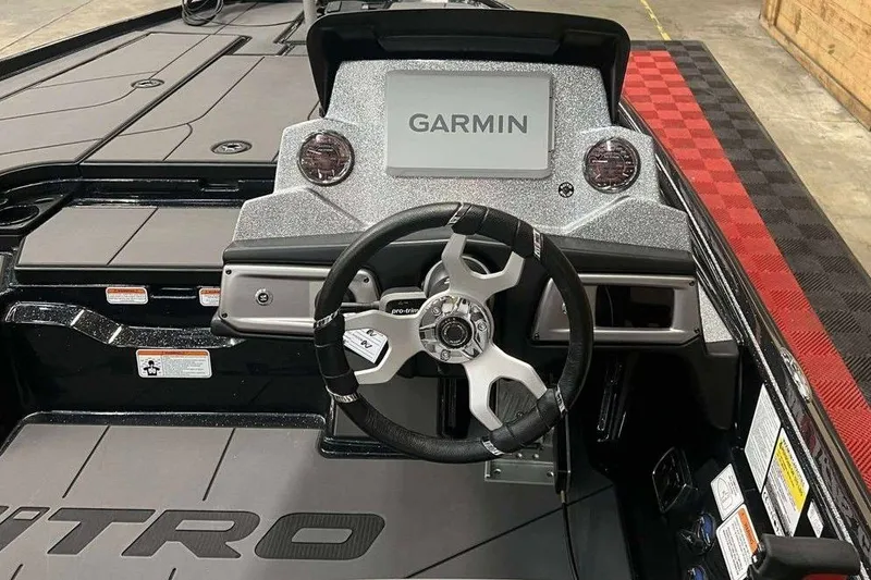 Slide: The Image of 2026 Nitro Z20 XL Pro boat dashboard with Garmin display and steering wheel. - 4