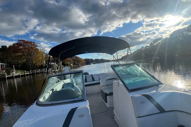 Slide: The Image of 2017 Regal 23 OBX boat on a scenic river with blue sky and clouds. - 13