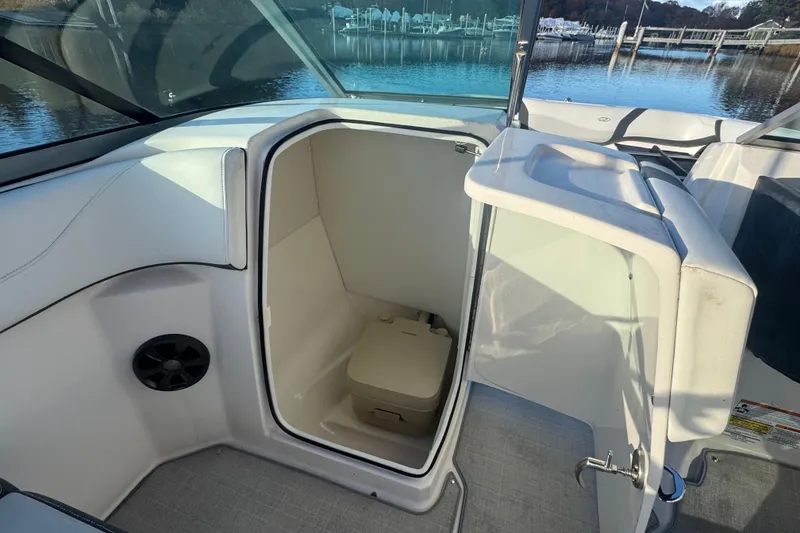 Slide: The Image of 2017 Regal 23 OBX boat interior with open compartment and portable toilet. - 15