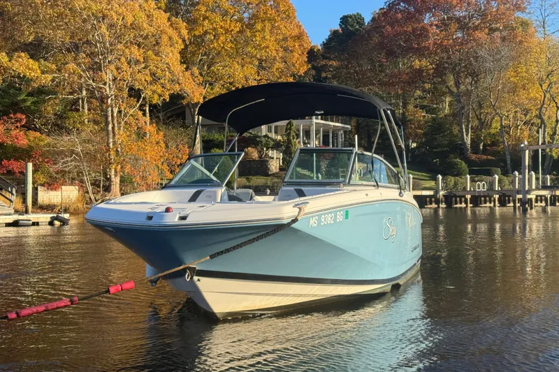 Slide: The Image of 2017 Regal 23 OBX boat on a serene lake with autumn foliage. - 19