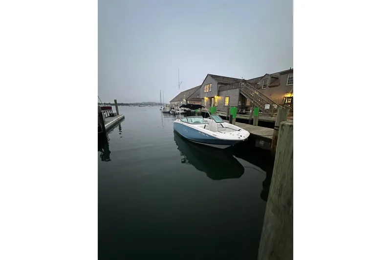 Slide: The Image of 2017 Regal 23 OBX boat docked at a marina during twilight. - 22