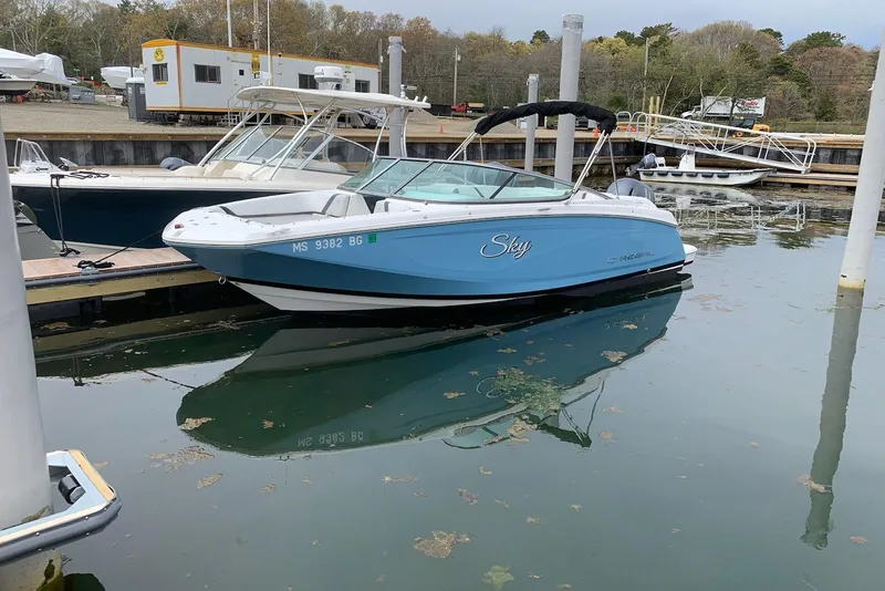 Slide: The Image of 2017 Regal 23 OBX boat named "Sky" docked in a marina. - 23