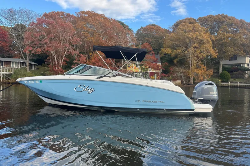 Slide: The Image of 2017 Regal 23 OBX boat on calm water, surrounded by autumn trees. - 3