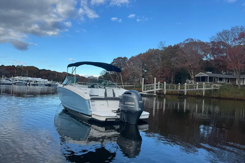 Slide: The Image of 2017 Regal 23 OBX boat with Yamaha engine on calm water, surrounded by autumn trees. - 5