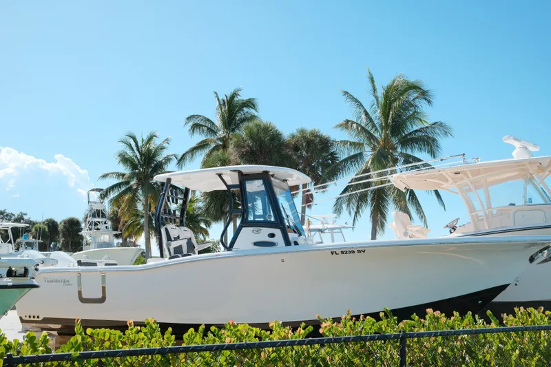 The Image of 2021 Tidewater 292 CC Adventure boat docked with palm trees in the background. - 0