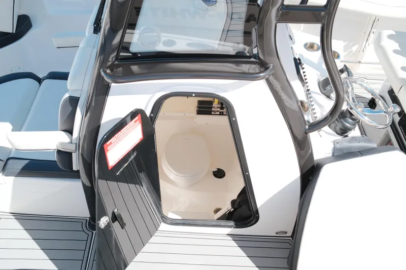 Slide: The Image of 2021 Tidewater 292 CC Adventure boat interior with open storage compartment. - 13