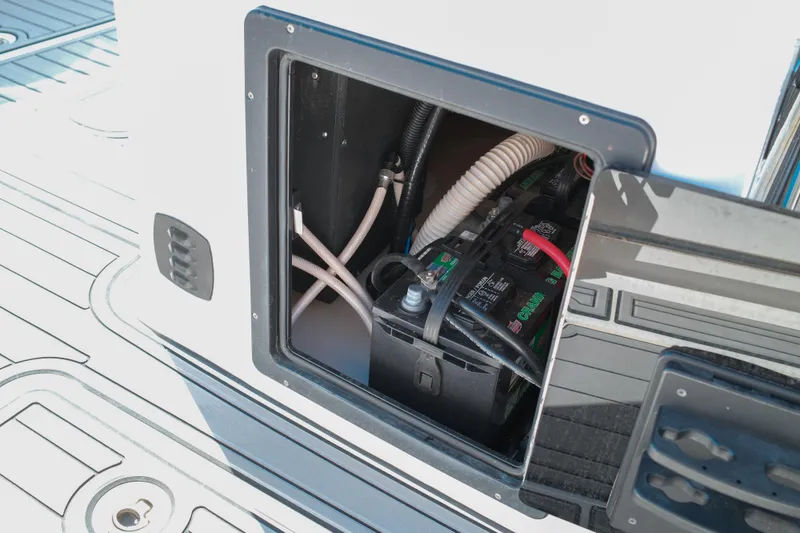 Slide: The Image of Battery compartment of 2021 Tidewater 292 CC Adventure boat, showing wiring and connections. - 16