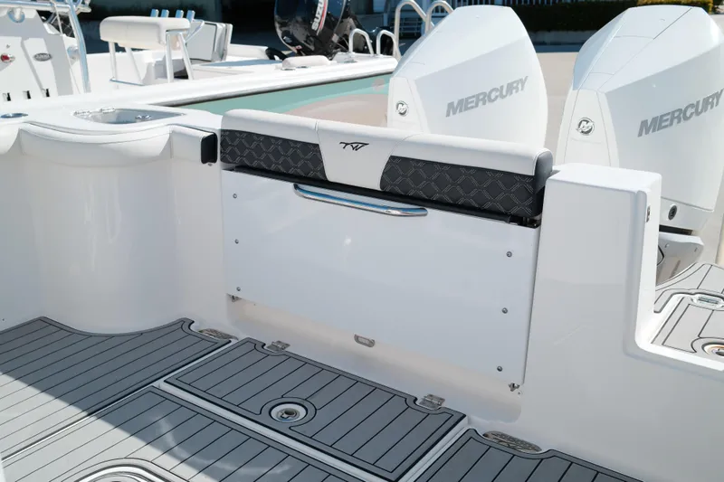 Slide: The Image of 2021 Tidewater 292 CC Adventure boat with Mercury engines, featuring sleek deck design. - 19