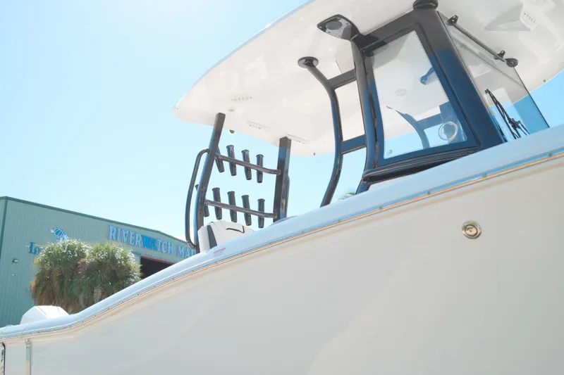 Slide: The Image of 2021 Tidewater 292 CC Adventure boat at Riverwatch Marina, showcasing sleek design and structure. - 22