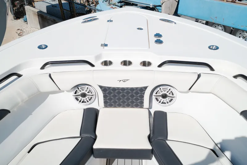 Slide: The Image of 2021 Tidewater 292 CC Adventure boat interior with cushioned seating and speakers. - 7