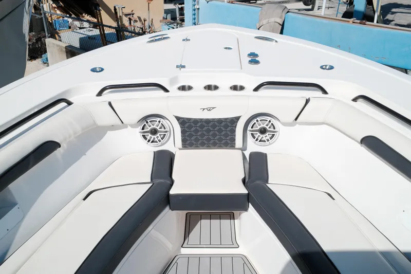 Slide: The Image of 2021 Tidewater 292 CC Adventure boat interior with cushioned seating and speakers. - 8