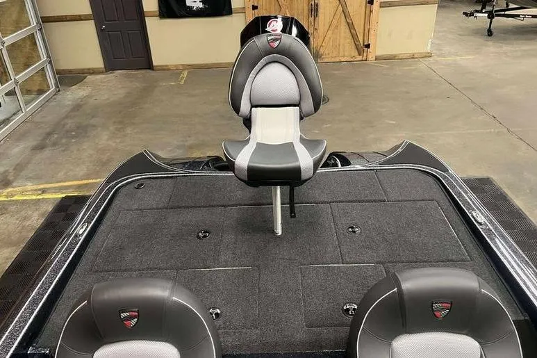 Slide: The Image of 2026 Triton 19 TrX Patriot boat interior with gray seating and spacious deck. - 6