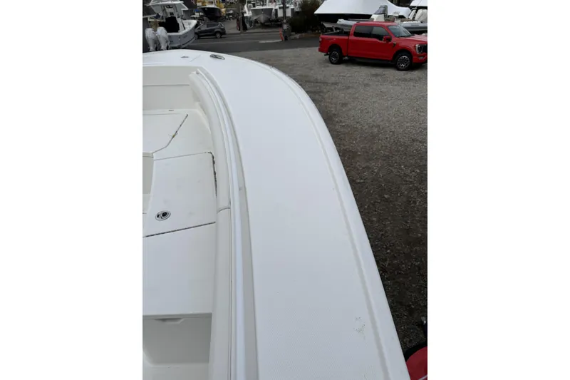 Slide: The Image of 2026 Regulator 28 boat deck with red truck in background at marina. - 11