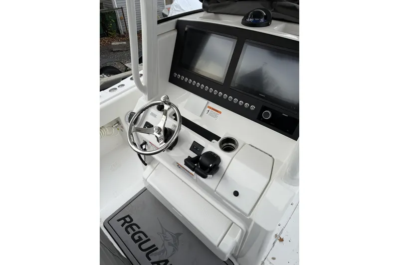 Slide: The Image of 2026 Regulator 28 boat console with dual screens and steering wheel. - 14