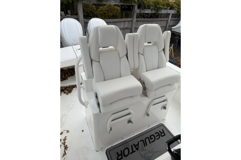 Slide: The Image of 2026 Regulator 28 boat with dual white captain's chairs and Regulator branding. - 15