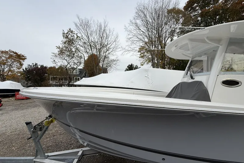 Slide: The Image of 2026 Regulator 28 boat on trailer, surrounded by trees and covered boats. - 3