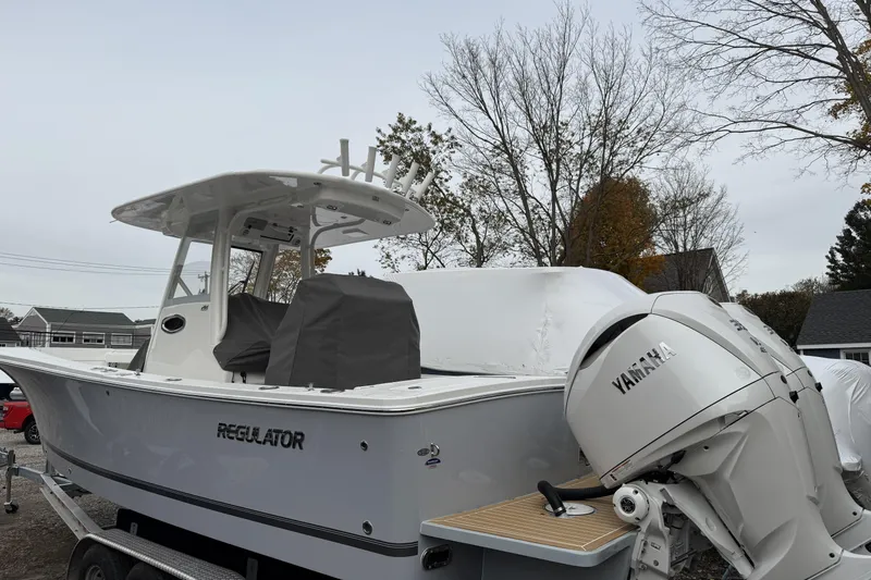 Slide: The Image of 2026 Regulator 28 boat with Yamaha engine, parked outdoors on a trailer. - 5