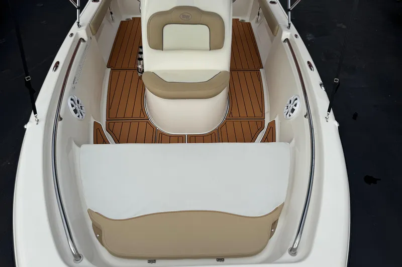 Slide: The Image of 2017 Key West 189 FS boat interior with cushioned seating and teak-style flooring. - 103