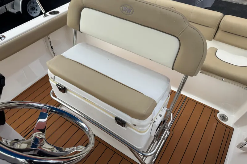 Slide: The Image of 2017 Key West 189 FS boat interior with cushioned seating and steering wheel. - 104