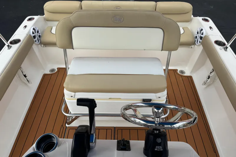 Slide: The Image of 2017 Key West 189 FS boat interior with beige seating and wooden deck. - 105
