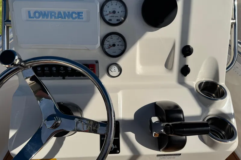 Slide: The Image of 2017 Key West 189 FS boat with blue canopy on trailer, parked outdoors. - 21