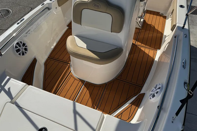 Slide: The Image of 2017 Key West 189 FS boat interior with tan seating and wood-style flooring. - 49