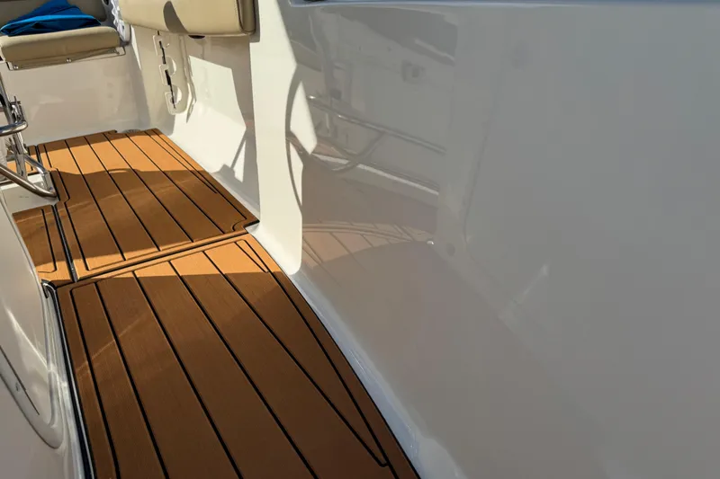 Slide: The Image of 2017 Key West 189 FS boat interior with tan seating and wood-patterned flooring. - 52