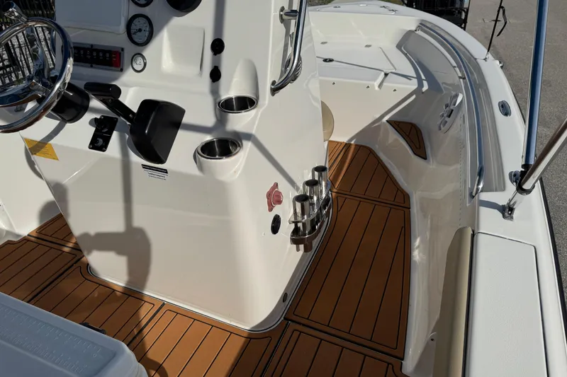 Slide: The Image of 2017 Key West 189 FS boat interior with steering wheel and wood flooring. - 64
