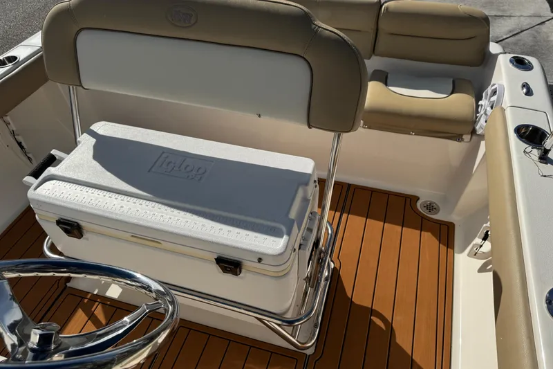 Slide: The Image of 2017 Key West 189 FS boat interior with Yamaha 115 engine, beige seating, and speaker. - 68