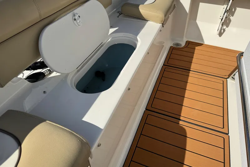 Slide: The Image of 2017 Key West 189 FS boat interior with steering console and cushioned seating. - 74