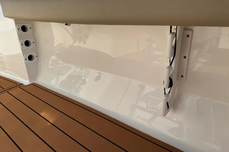 Slide: The Image of 2017 Key West 189 FS boat interior with tan seating and wood-style flooring. - 75