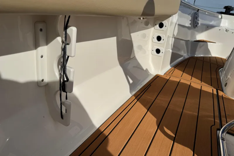 Slide: The Image of 2017 Key West 189 FS boat interior with tan seating and wood-style flooring. - 76