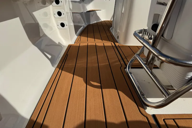 Slide: The Image of 2017 Key West 189 FS boat interior with open storage compartment and teak-style flooring. - 77