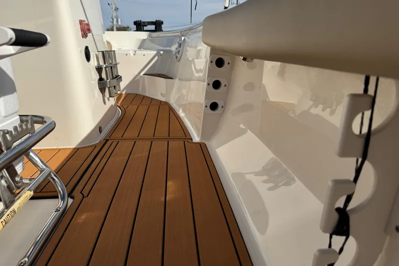 Slide: The Image of 2017 Key West 189 FS boat interior with rod holders and teak flooring. - 78