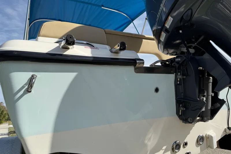 Slide: The Image of 2017 Key West 189 FS boat seat with tan and white upholstery, wooden deck. - 82