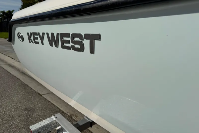 Slide: The Image of 2017 Key West 189 FS boat side view with logo on trailer. - 92