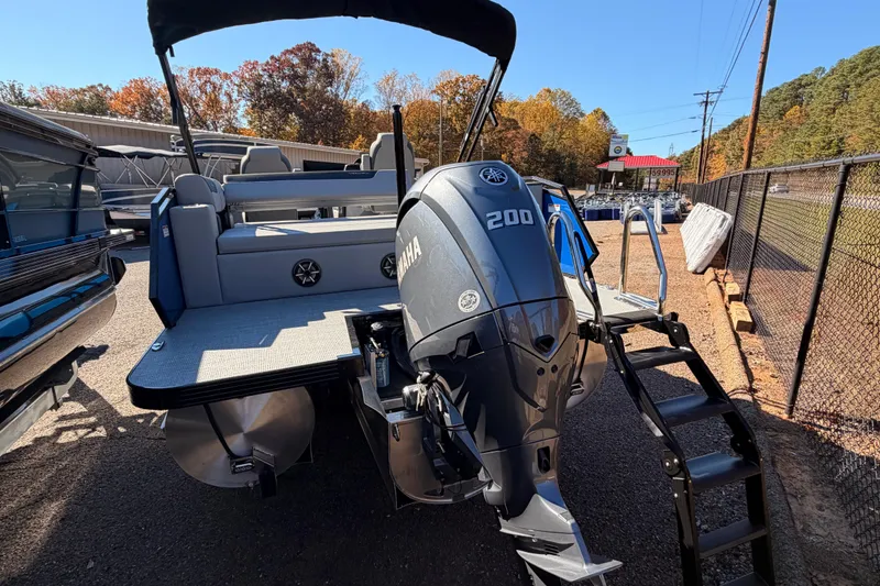 Slide: The Image of 2026 Veranda VR 235 VL pontoon boat with Yamaha 200 engine, parked outdoors. - 14