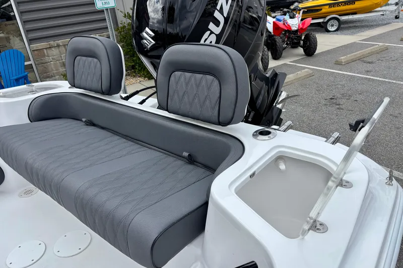 Slide: The Image of 2026 ALK2 Powerboats 23 CRX with gray seating and Suzuki engine in a parking lot. - 10