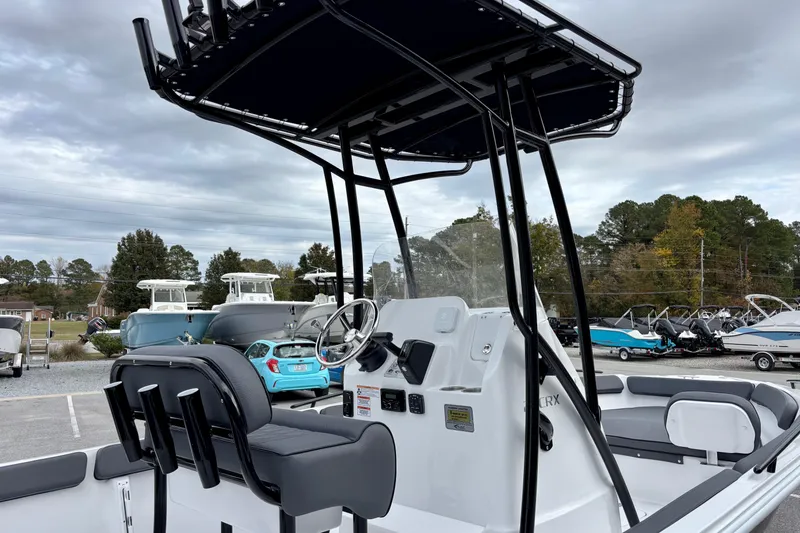 Slide: The Image of 2026 ALK2 Powerboats 23 CRX with sleek design, parked outdoors under cloudy sky. - 11