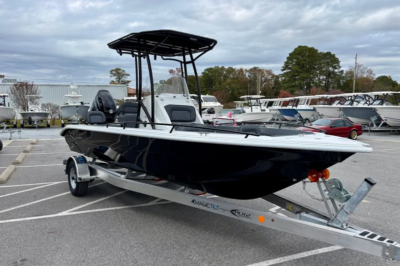 Slide: The Image of 2026 ALK2 Powerboats 23 CRX on trailer in parking lot, surrounded by other boats. - 6