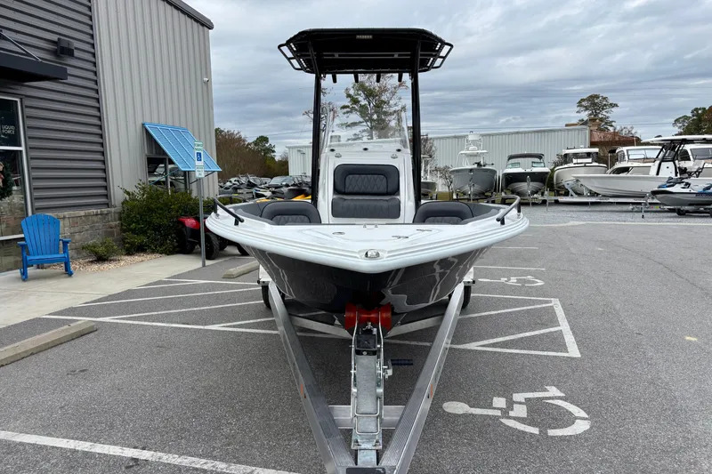 Slide: The Image of 2026 ALK2 Powerboats 23 CRX on trailer in parking lot, overcast sky. - 7