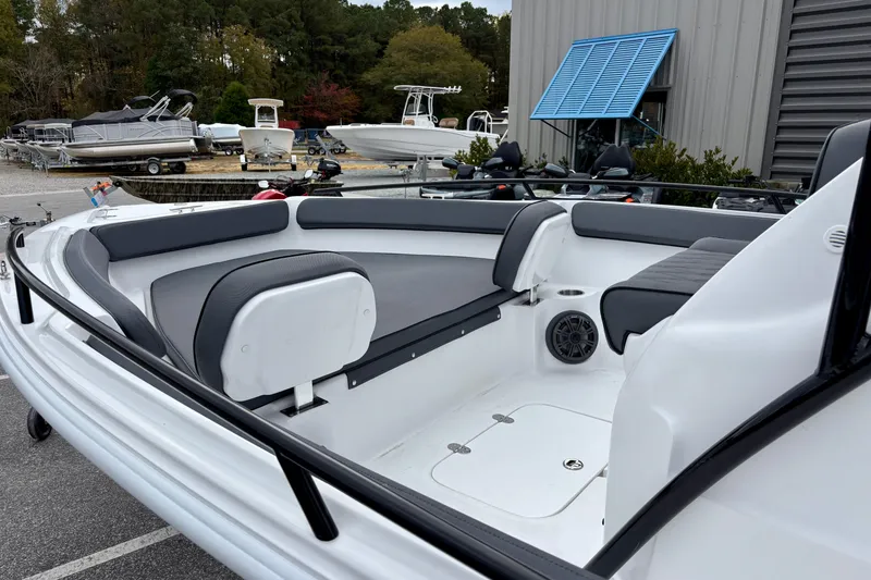Slide: The Image of 2026 ALK2 Powerboats 23 CRX interior with seating, docked near other boats. - 8