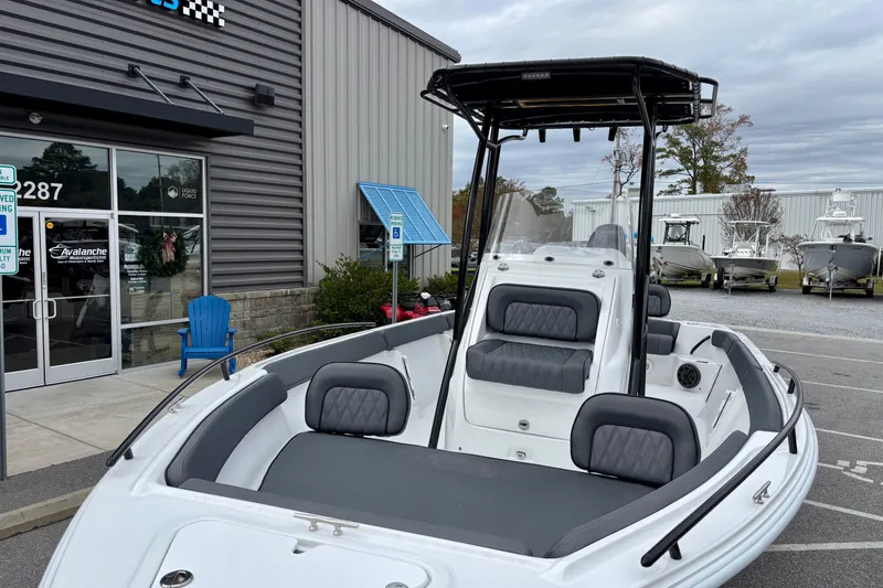 Slide: The Image of 2026 ALK2 Powerboats 23 CRX displayed outside a dealership, showcasing sleek design and seating. - 9