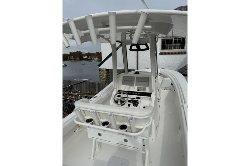 Slide: The Image of 2026 Regulator 25 boat with advanced Garmin navigation system, docked near waterfront. - 6