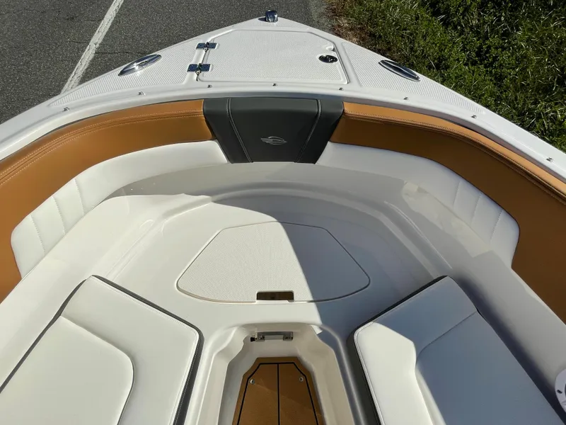 Slide: The Image of 2024 Chaparral 23 SSi OB boat bow seating area with tan and white upholstery. - 11