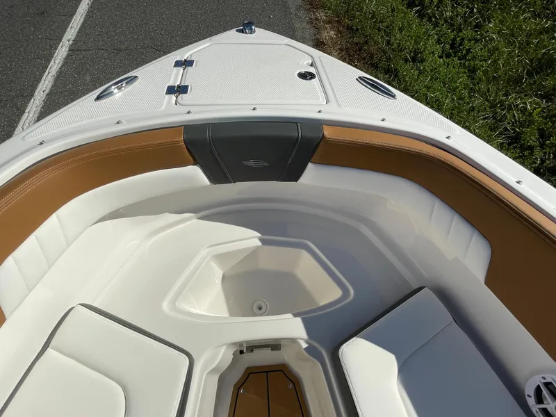 Slide: The Image of 2024 Chaparral 23 SSi OB boat bow seating area with tan and white upholstery. - 12