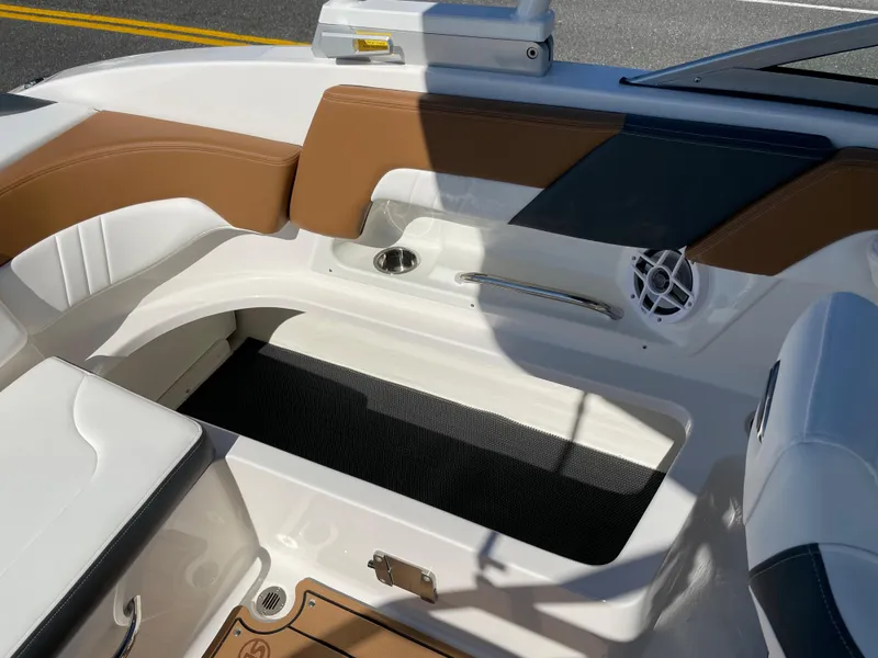 Slide: The Image of Interior seating of 2024 Chaparral 23 SSi OB boat with brown and white upholstery. - 32